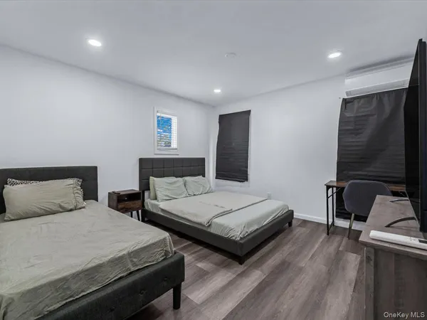 a bedroom with two beds and a desk
