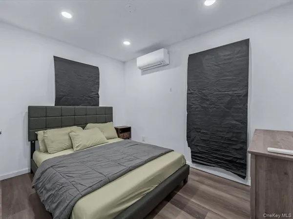 a bedroom with a bed and a potted plant