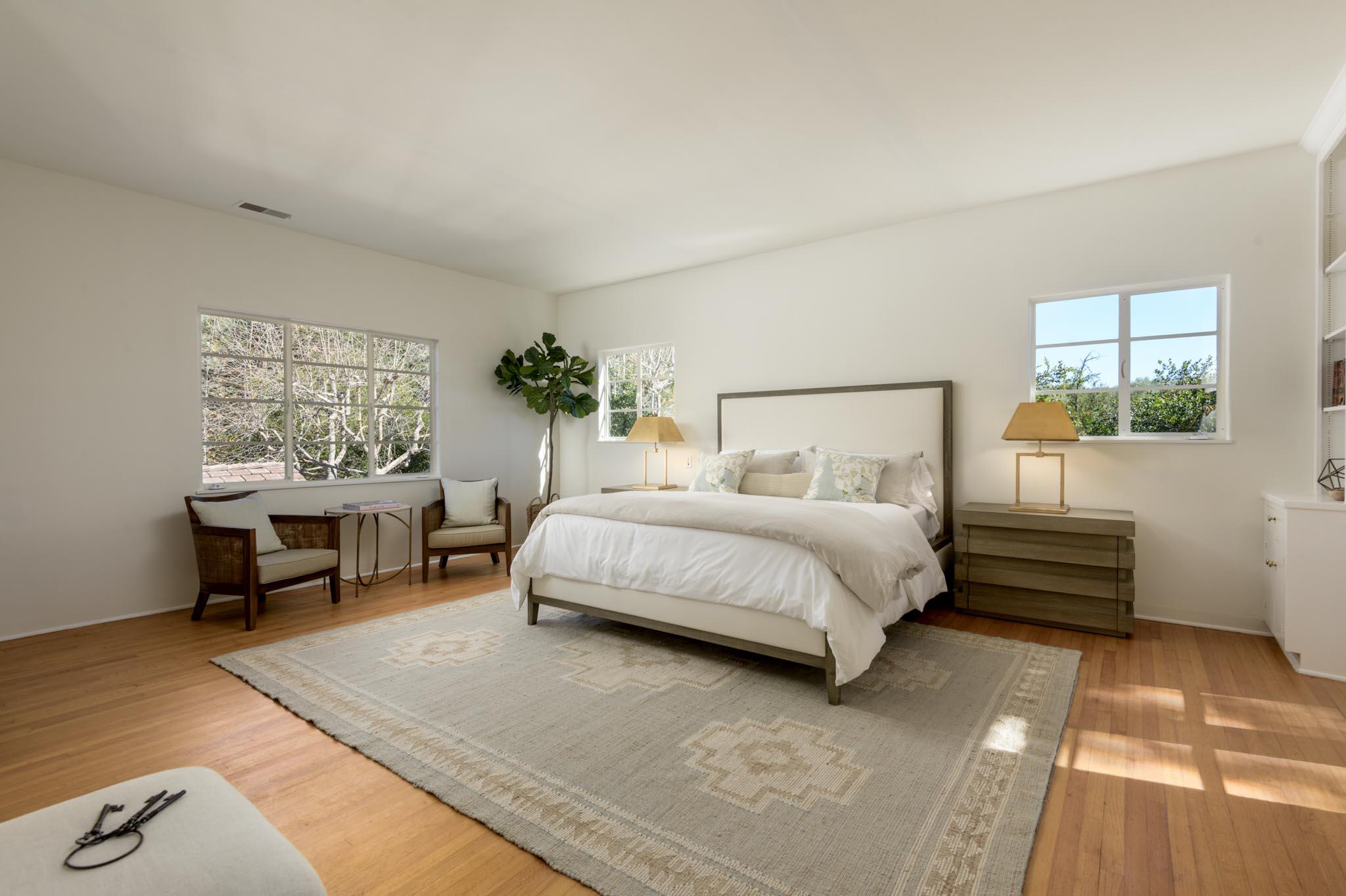 605 San Ysidro Road Montecito, CA 93108 - Photo 16 of 32 a bedroom with a bed wooden floor and window