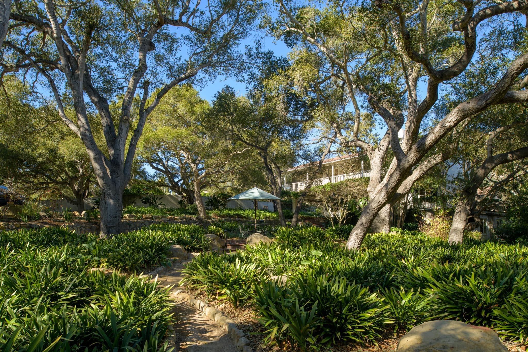 605 San Ysidro Road Montecito, CA 93108 - Photo 4 of 32 a backyard of a house with lots of green space