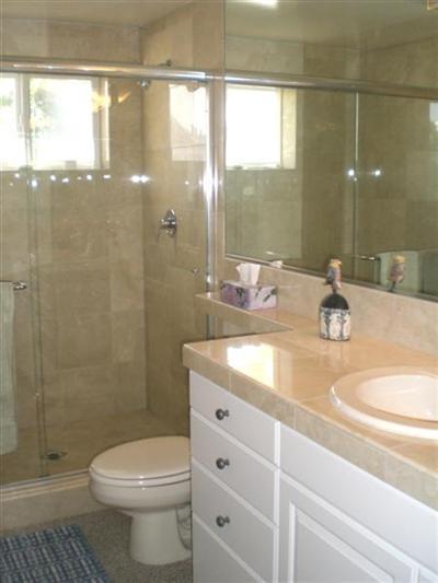 3511 Sunset Lane Oxnard, CA 93035 - Photo 3 of 9 a bathroom with a granite countertop sink a toilet a mirror and shower