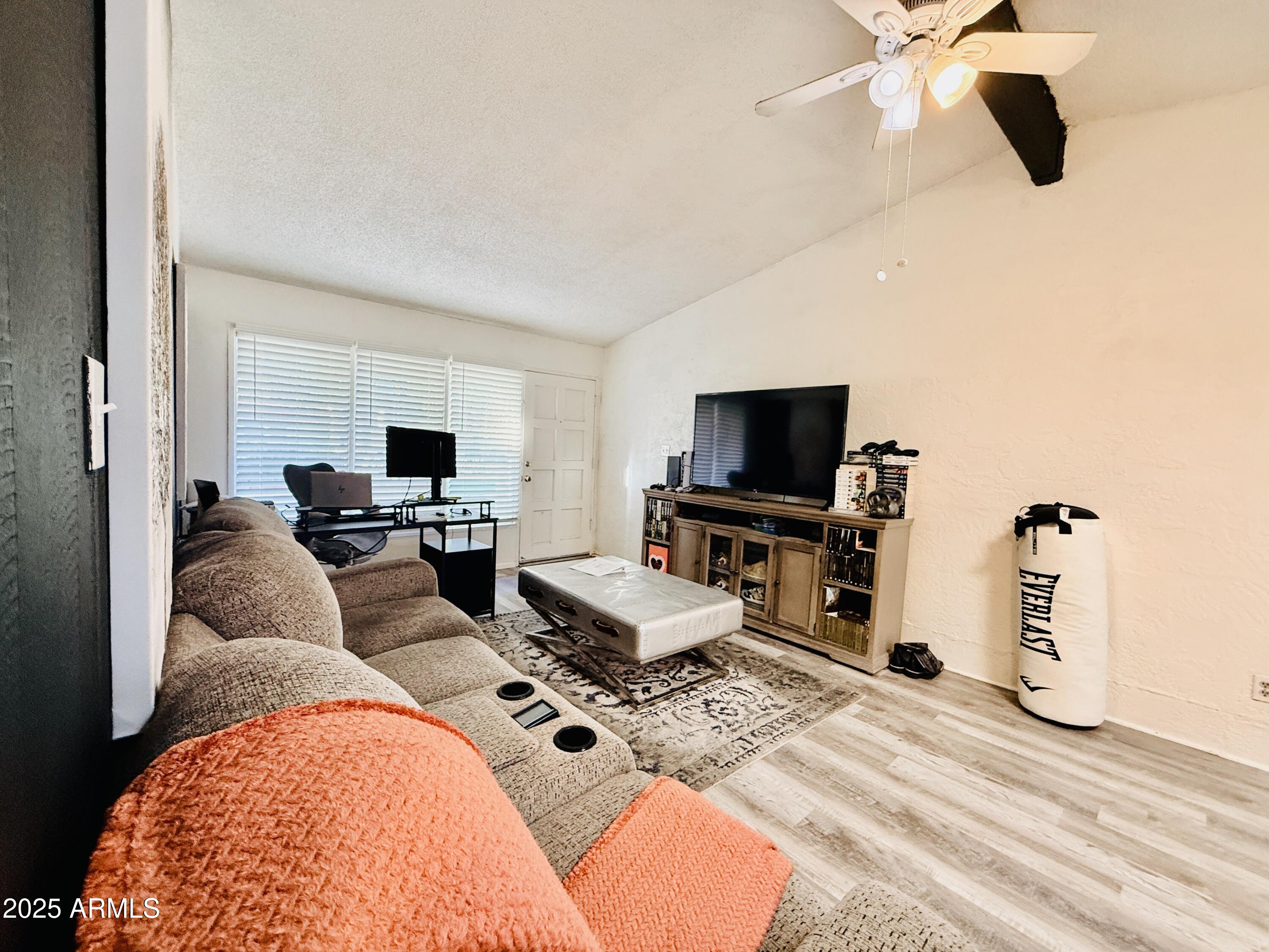 625 South Power Road, Unit 350 Mesa, AZ 85206 - Photo 4 of 20 a living room with furniture and a flat screen tv