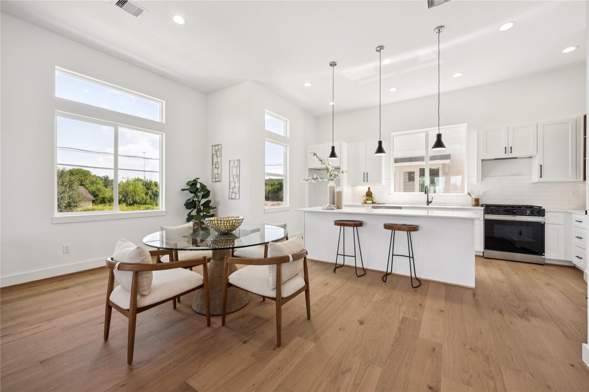 2810 Mills Street Houston, TX 77026 - Photo 11 of 29 a kitchen with stainless steel appliances kitchen island a large window a sink and a counter