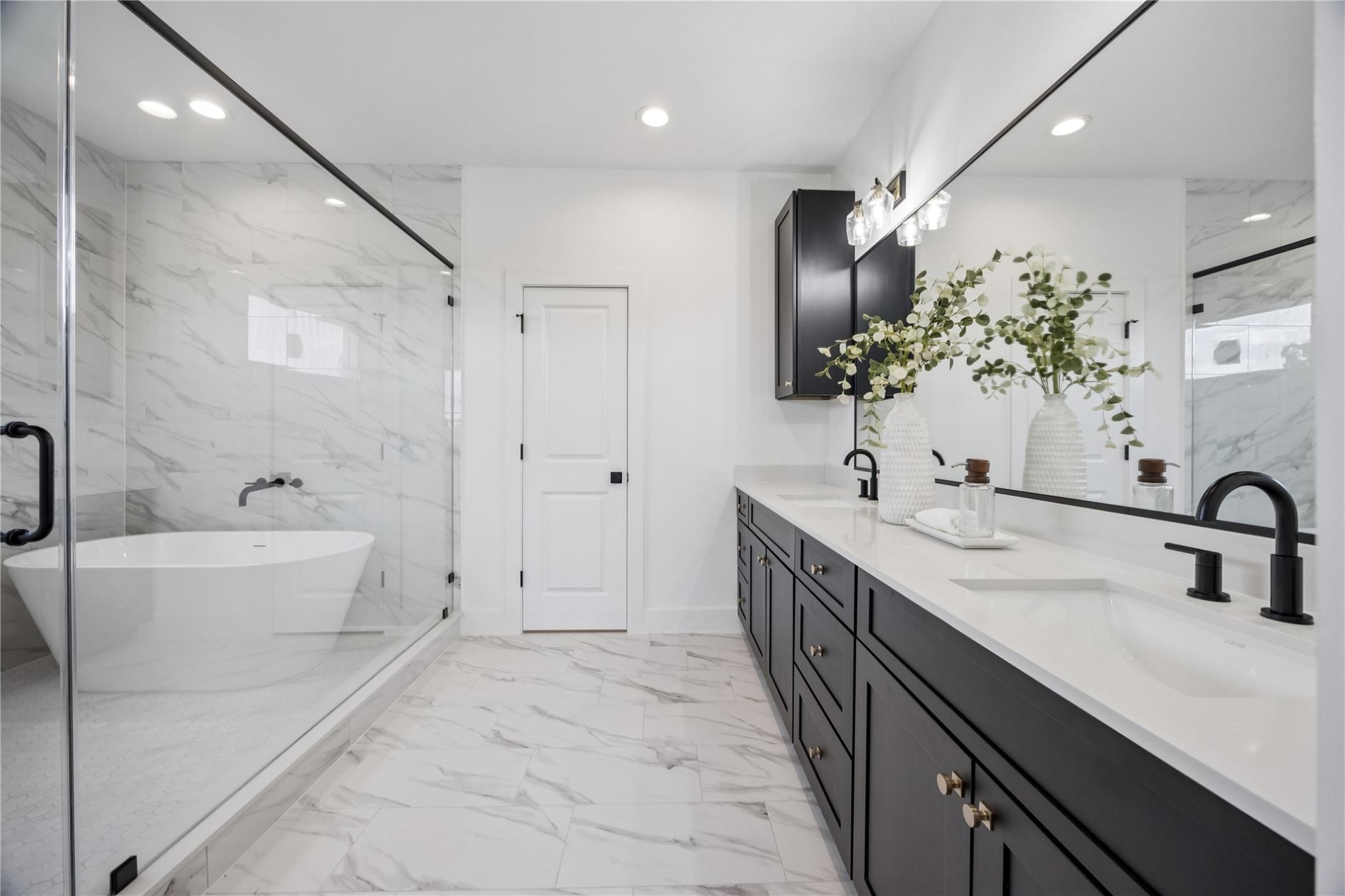 2810 Mills Street Houston, TX 77026 - Photo 18 of 29 a bathroom with a double vanity sink a large mirror and shower