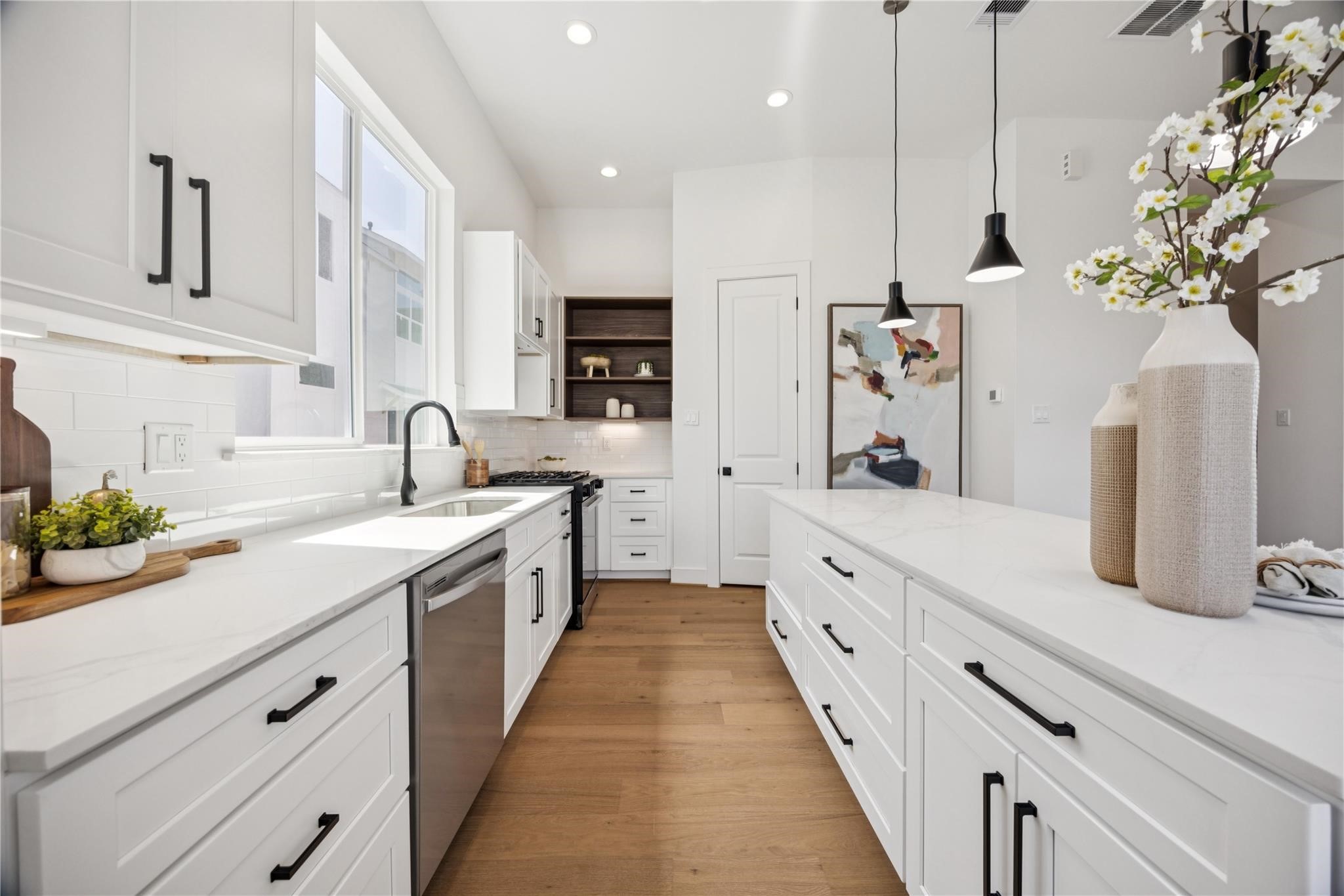 2810 Mills Street Houston, TX 77026 - Photo 9 of 29 a spacious kitchen with stainless steel appliances kitchen island granite countertop a sink and cabinets