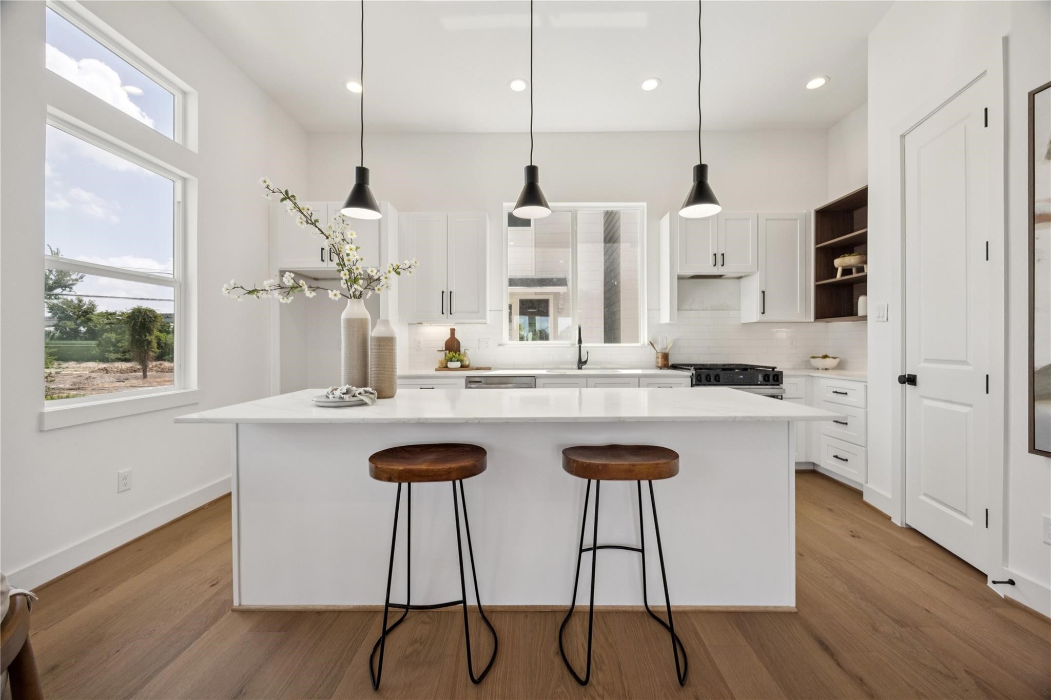 2810 Mills Street Houston, TX 77026 - Photo 10 of 29 a kitchen with stainless steel appliances granite countertop a kitchen island a stove a sink and a refrigerator