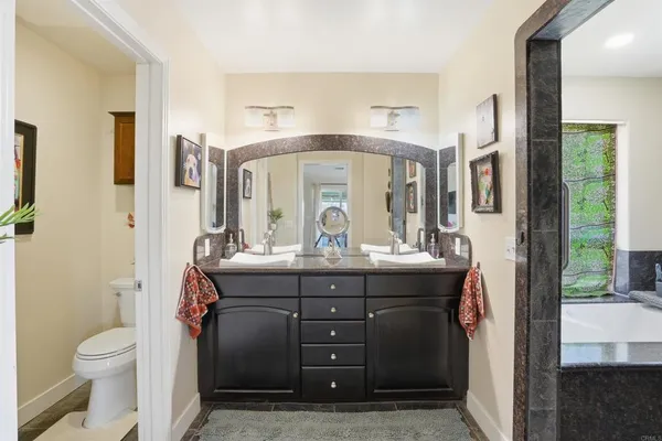 a bedroom with a bed a window and a chandelier
