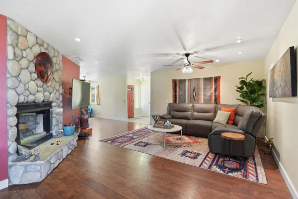 a kitchen with stainless steel appliances granite countertop a kitchen island a stove a table and chairs with wooden floor