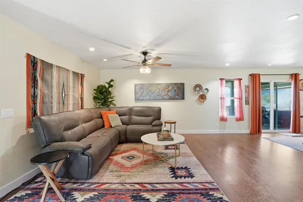 a large kitchen with stainless steel appliances granite countertop a refrigerator a sink dishwasher a stove and a refrigerator with wooden cabinets