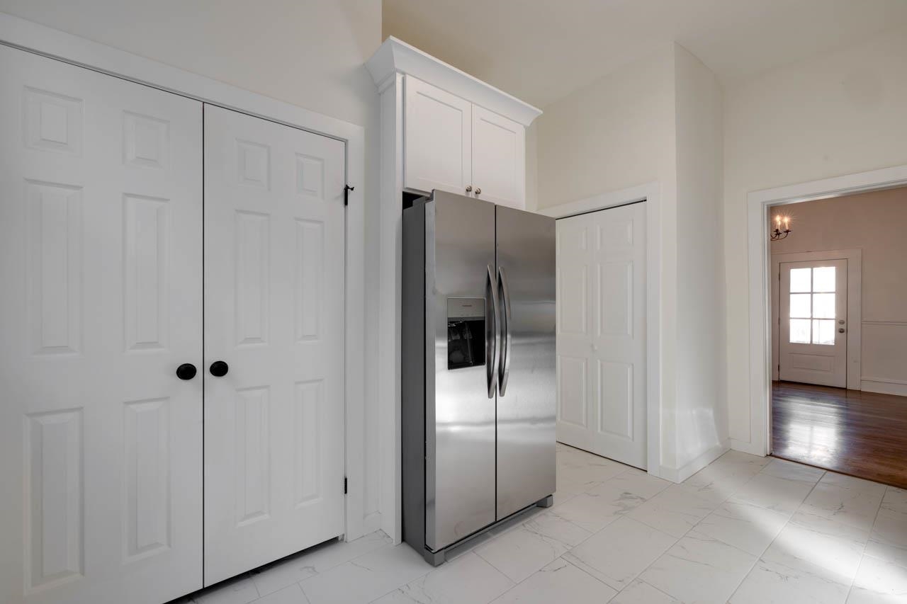 513 South Cox Street Memphis, TN 38104 - Photo 19 of 39 a view of a refrigerator in kitchen and white cabinets