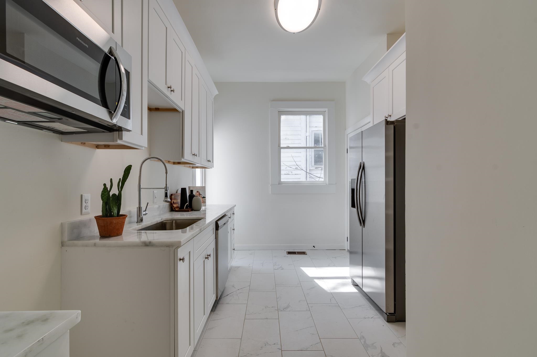 513 South Cox Street Memphis, TN 38104 - Photo 20 of 39 a kitchen with stainless steel appliances granite countertop a refrigerator and a sink