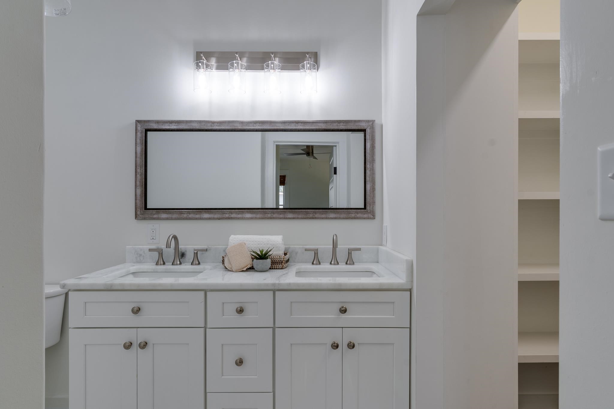 513 South Cox Street Memphis, TN 38104 - Photo 27 of 39 a bathroom with mirror a sink and two mirror