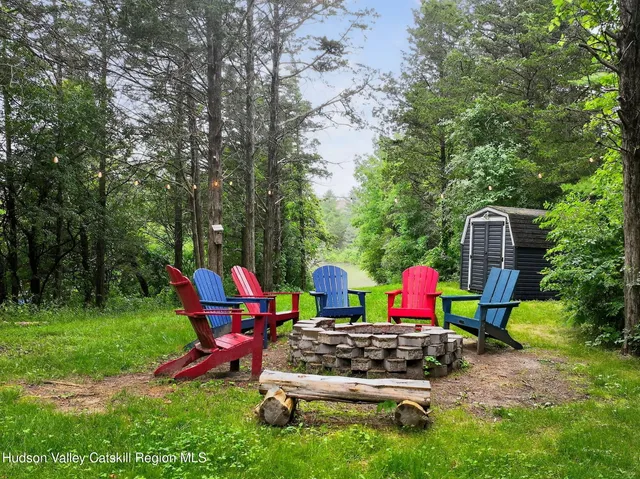 a view of a bedroom with furniture and window