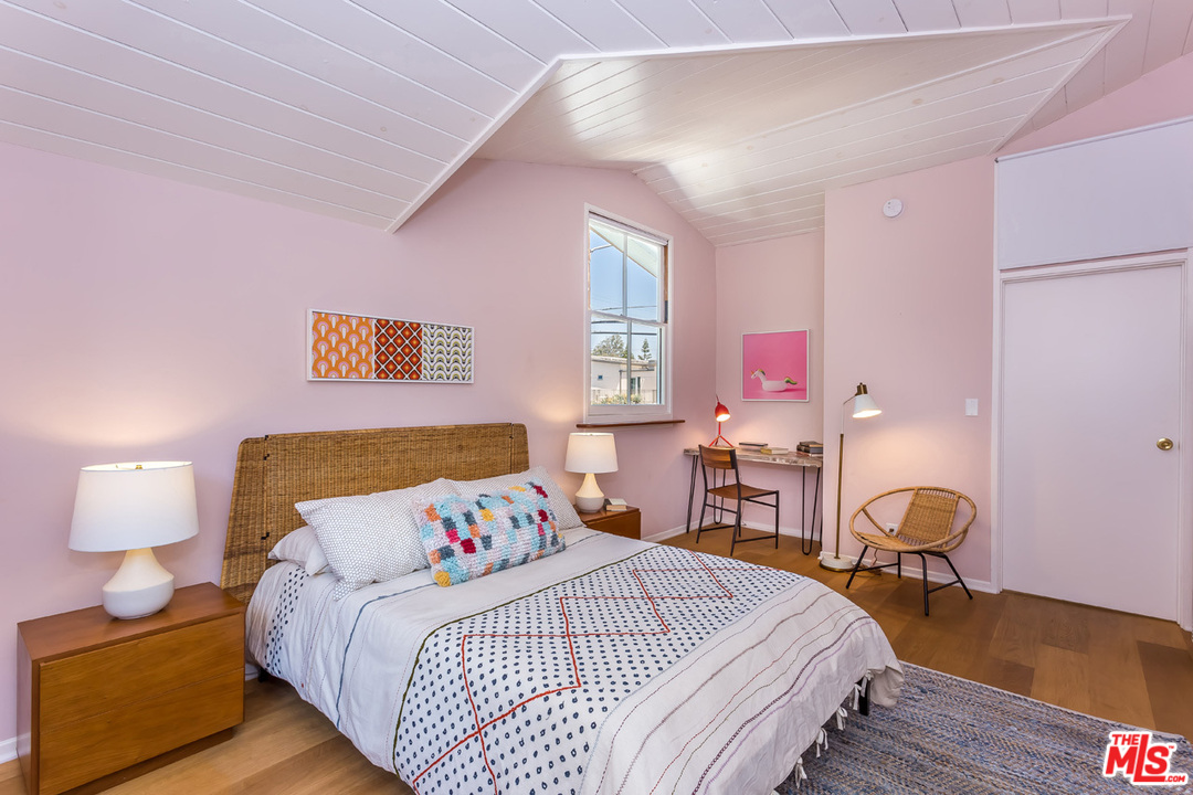 754 Marco Place Venice, CA 90291 - Photo 21 of 39 a bedroom with a bed and wooden floor