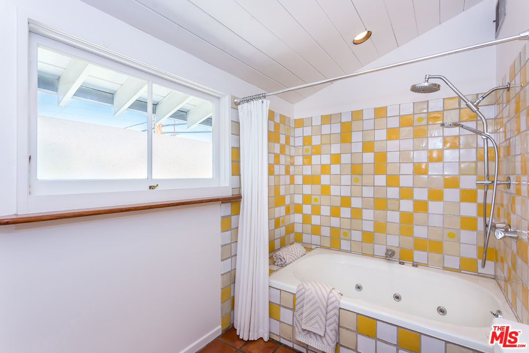 754 Marco Place Venice, CA 90291 - Photo 24 of 39 a bathroom with a bathtub and a shower