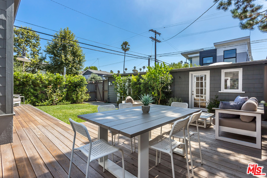 754 Marco Place Venice, CA 90291 - Photo 25 of 39 a view of a patio with table and chairs with wooden floor and plants
