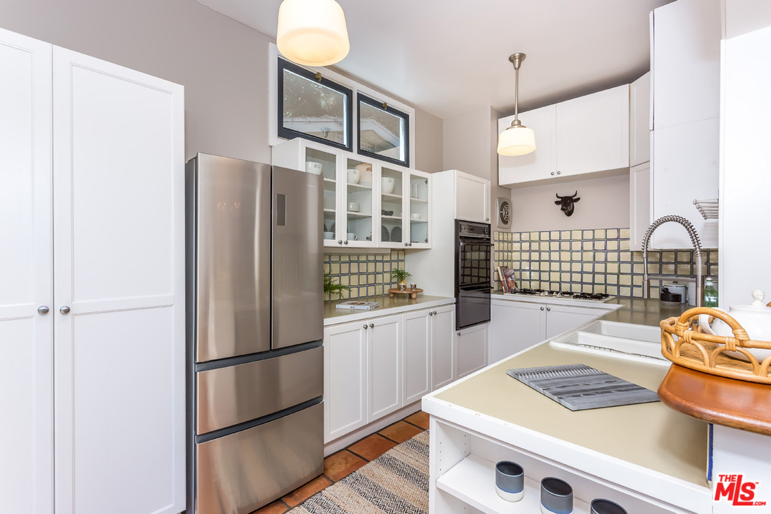 754 Marco Place Venice, CA 90291 - Photo 10 of 39 a kitchen with stainless steel appliances granite countertop a refrigerator and a stove top oven