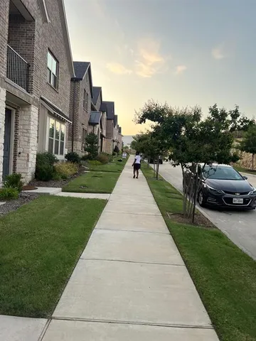 a view of a street with a cars parked