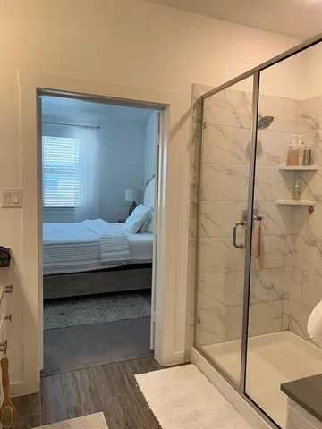 a bedroom with a bed and wooden floor