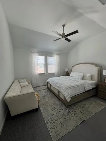 a bedroom with a bed and a couch