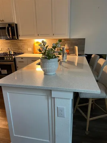 a kitchen with a table chairs and a stove top oven