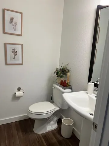 a white toilet sitting next to a bathroom sink