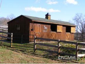 206 Burt Blackwell Road Mill Spring, NC 28756 - Photo 11 of 16 a view of a house with a door and wooden fence