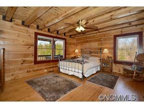 206 Burt Blackwell Road Mill Spring, NC 28756 - Photo 5 of 16 a spacious bedroom with a bed and a window