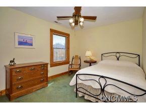 206 Burt Blackwell Road Mill Spring, NC 28756 - Photo 7 of 16 a bedroom with a bed and a dresser