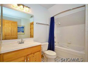 206 Burt Blackwell Road Mill Spring, NC 28756 - Photo 8 of 16 a bathroom with a sink a toilet and shower