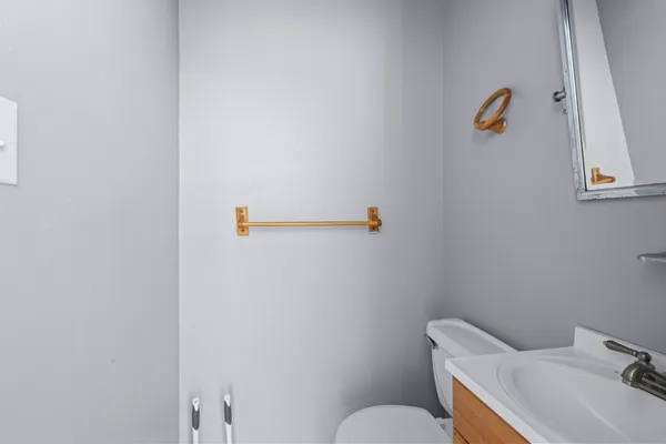 a bathroom with a sink a toilet and a mirror