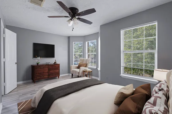 a bedroom with a bed and a flat screen tv