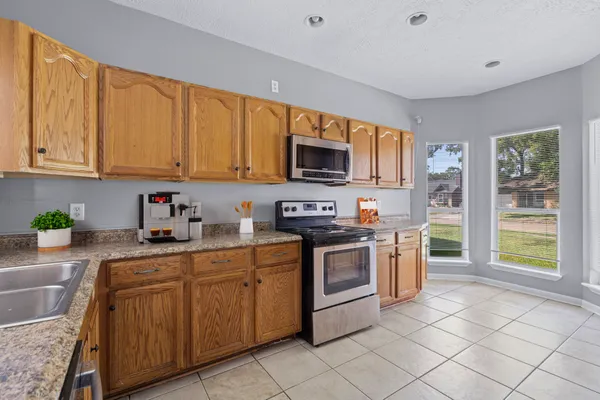 a kitchen with stainless steel appliances granite countertop a stove sink and cabinets