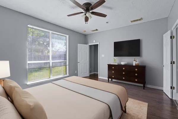 a bedroom with a bed and a flat screen tv