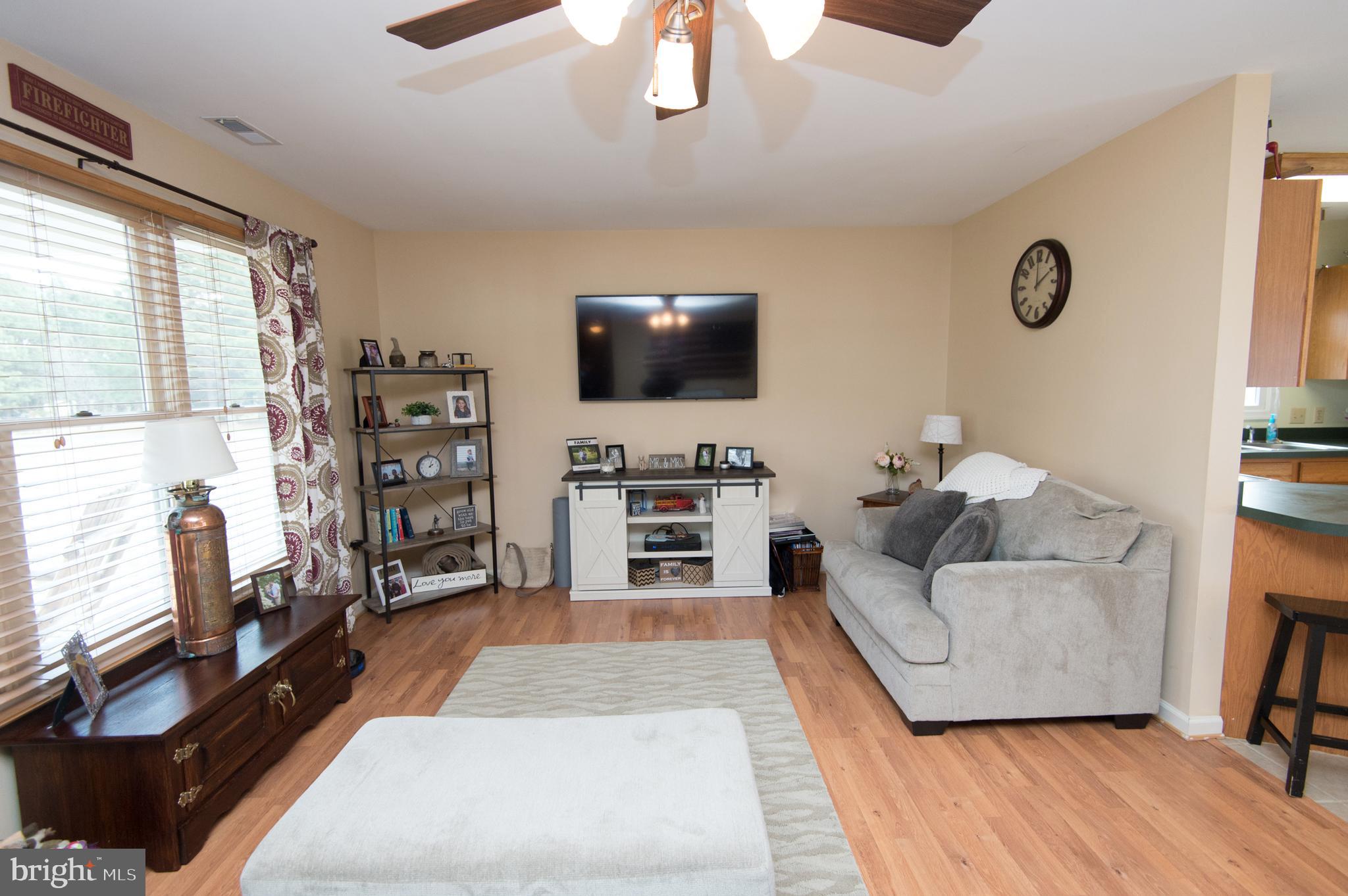 6568 Statum Road Preston, MD 21655 - Photo 2 of 49 a living room with furniture and a flat screen tv