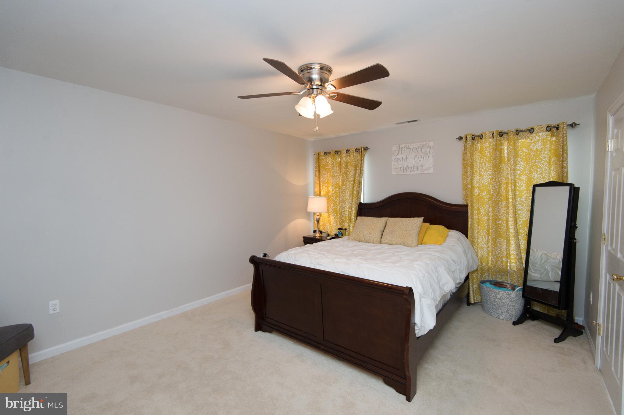 6568 Statum Road Preston, MD 21655 - Photo 14 of 49 a bedroom with a bed and a chandelier