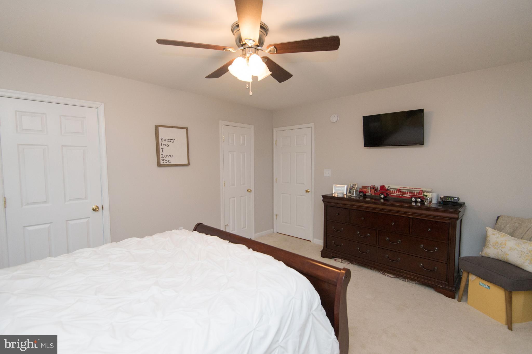 6568 Statum Road Preston, MD 21655 - Photo 16 of 49 a bedroom with a bed and a wall painting