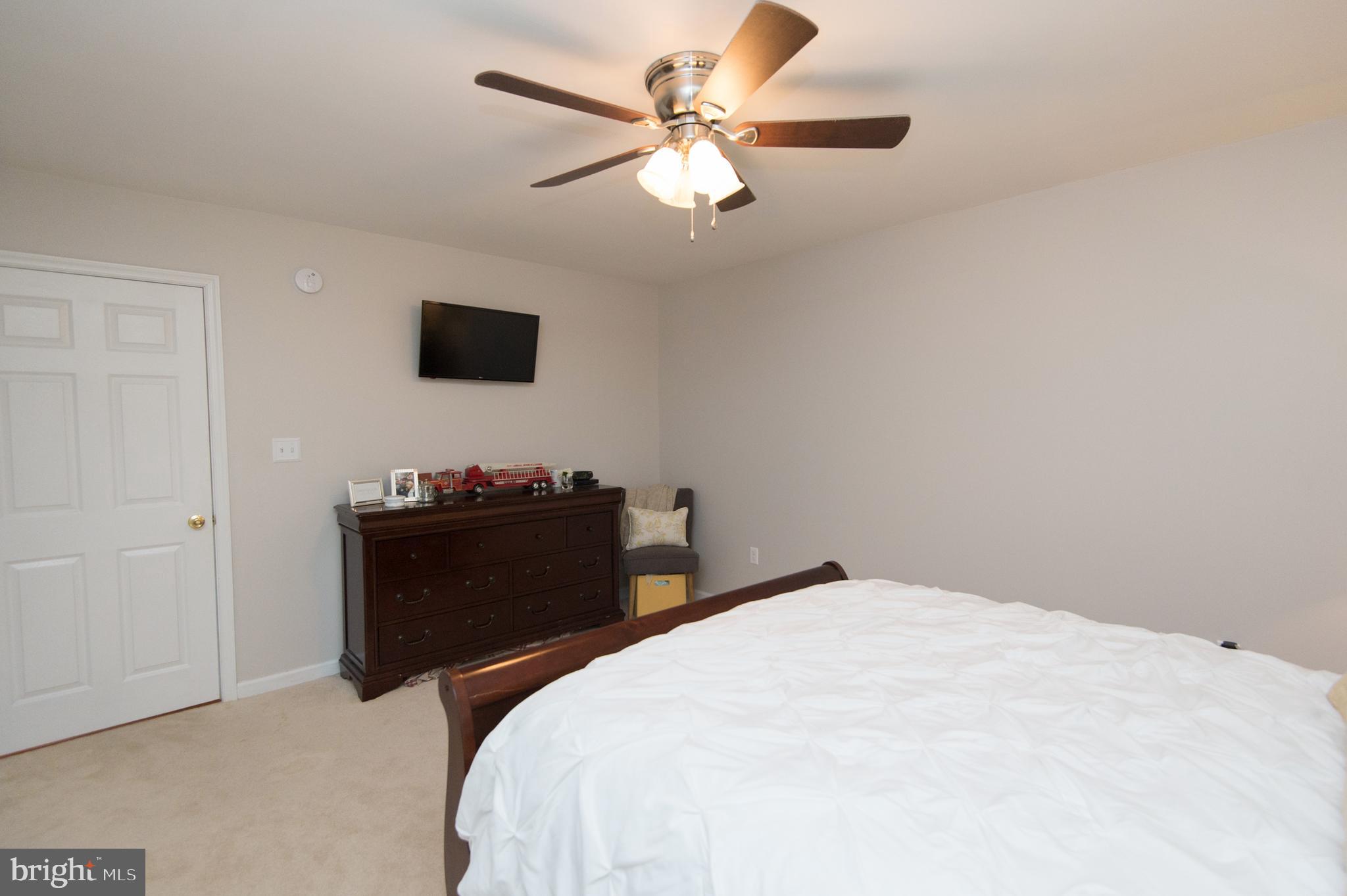 6568 Statum Road Preston, MD 21655 - Photo 17 of 49 a bedroom with a bed and a ceiling fan