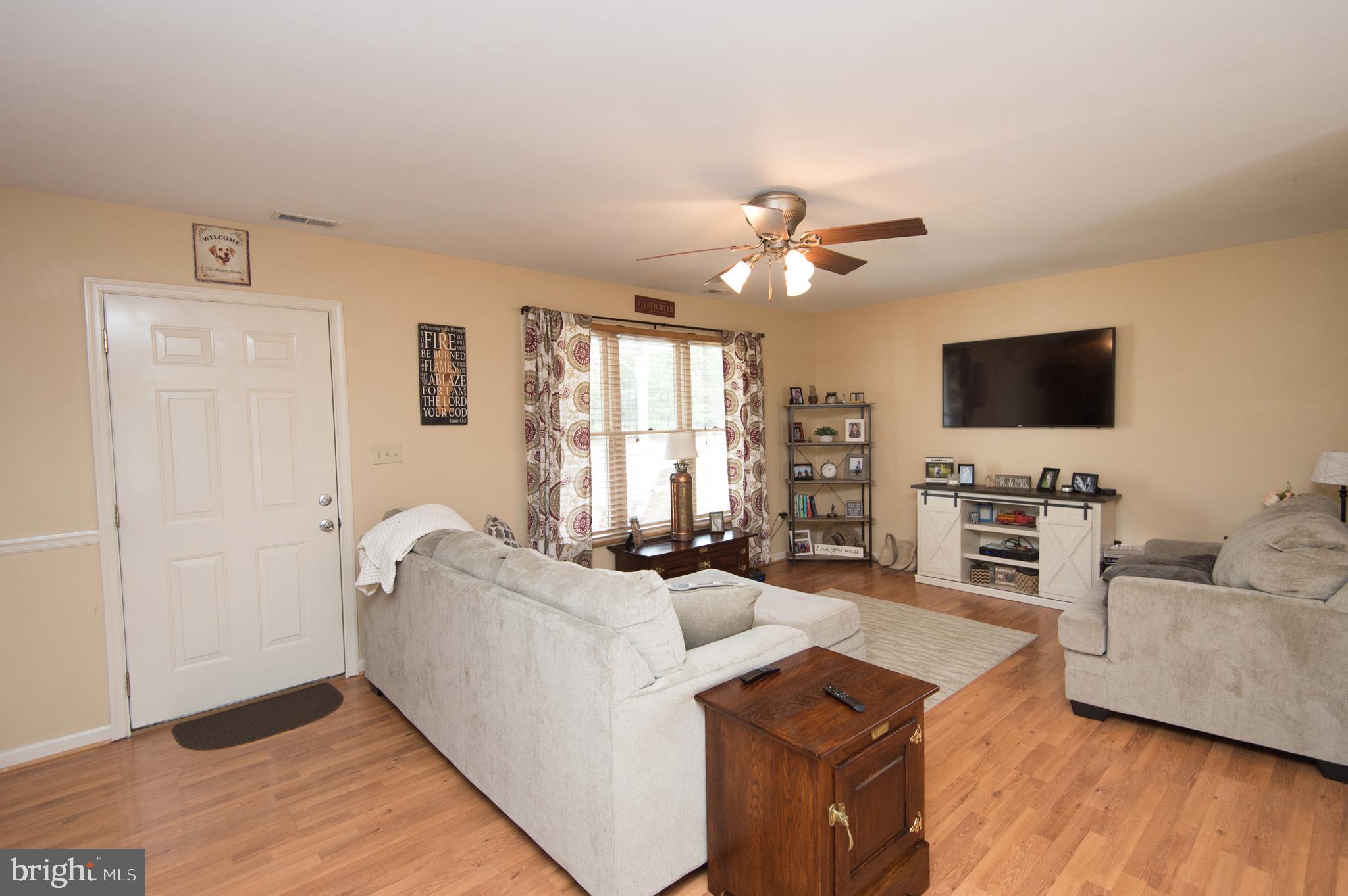 6568 Statum Road Preston, MD 21655 - Photo 3 of 49 a living room with furniture and a flat screen tv