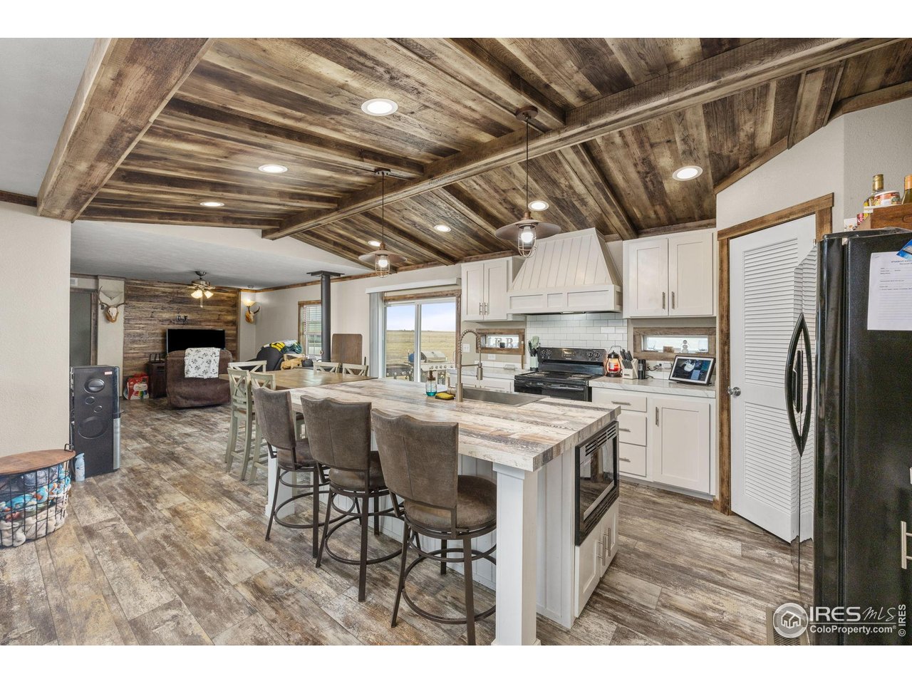 55102 County Road 21 Carr, CO 80612 - Photo 11 of 34 a kitchen with refrigerator and chairs