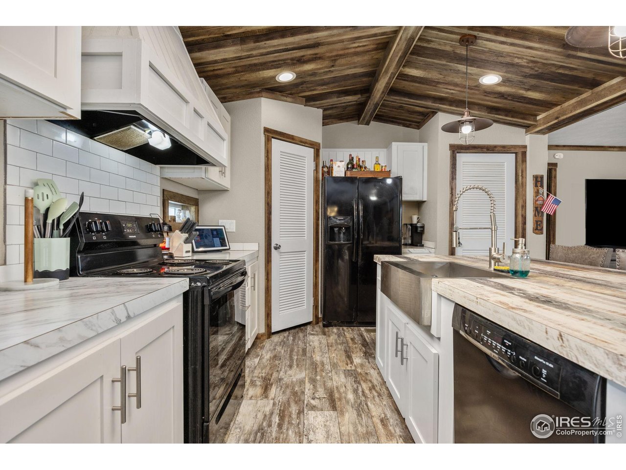 55102 County Road 21 Carr, CO 80612 - Photo 12 of 34 a kitchen with stainless steel appliances granite countertop a sink a stove and cabinets
