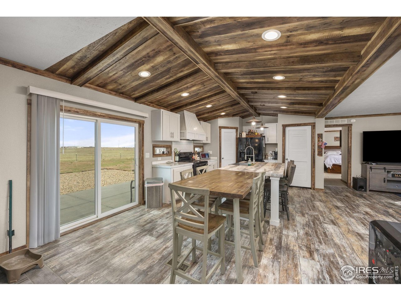 55102 County Road 21 Carr, CO 80612 - Photo 13 of 34 a dining room with furniture window and wooden floor