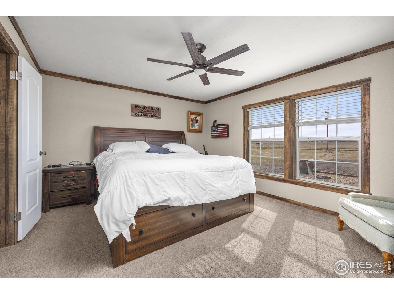 55102 County Road 21 Carr, CO 80612 - Photo 15 of 34 a bedroom with a large bed and a large window