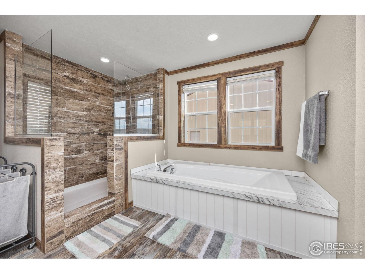 55102 County Road 21 Carr, CO 80612 - Photo 17 of 34 a bathroom with a tub a sink and a large mirror
