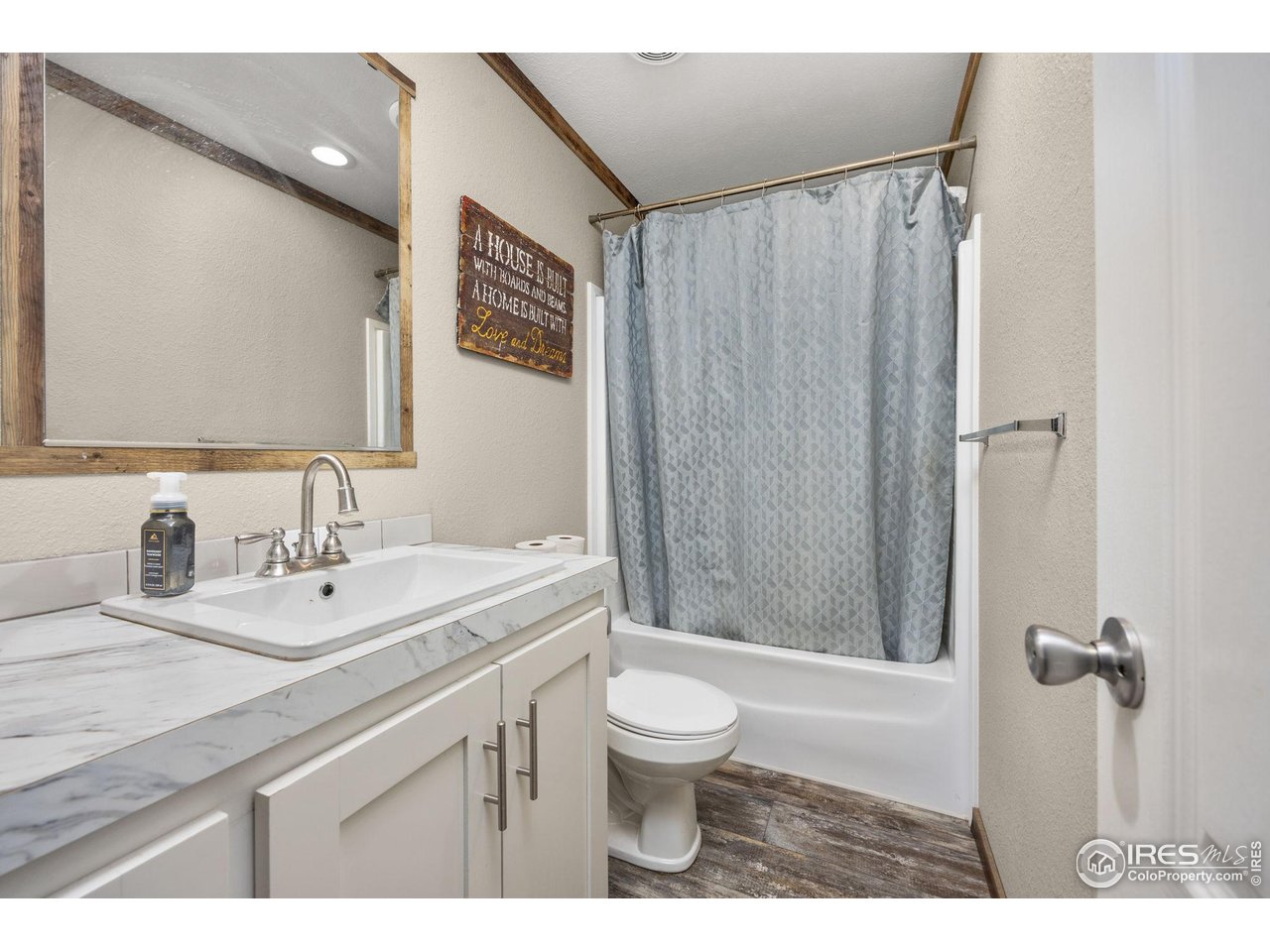 55102 County Road 21 Carr, CO 80612 - Photo 22 of 34 a bathroom with a sink a toilet a mirror and shower