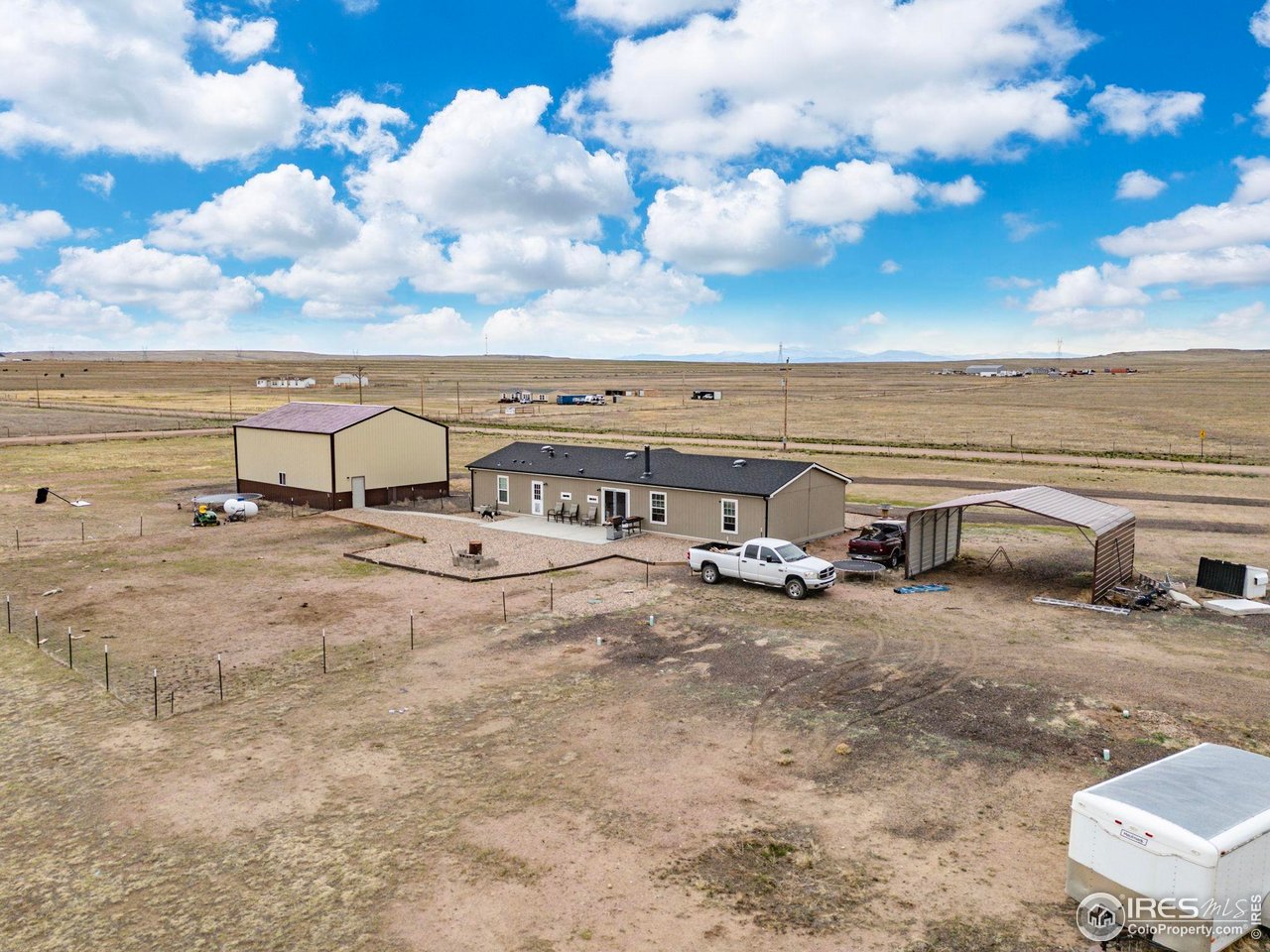 55102 County Road 21 Carr, CO 80612 - Photo 30 of 34 a view of a parking area with an outdoor space
