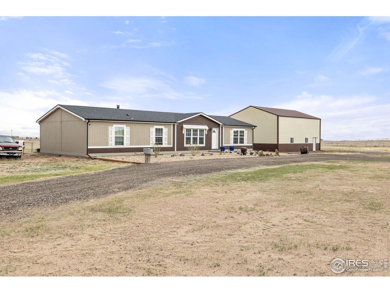 55102 County Road 21 Carr, CO 80612 - Photo 6 of 34 a very nice looking house with a big yard and large trees