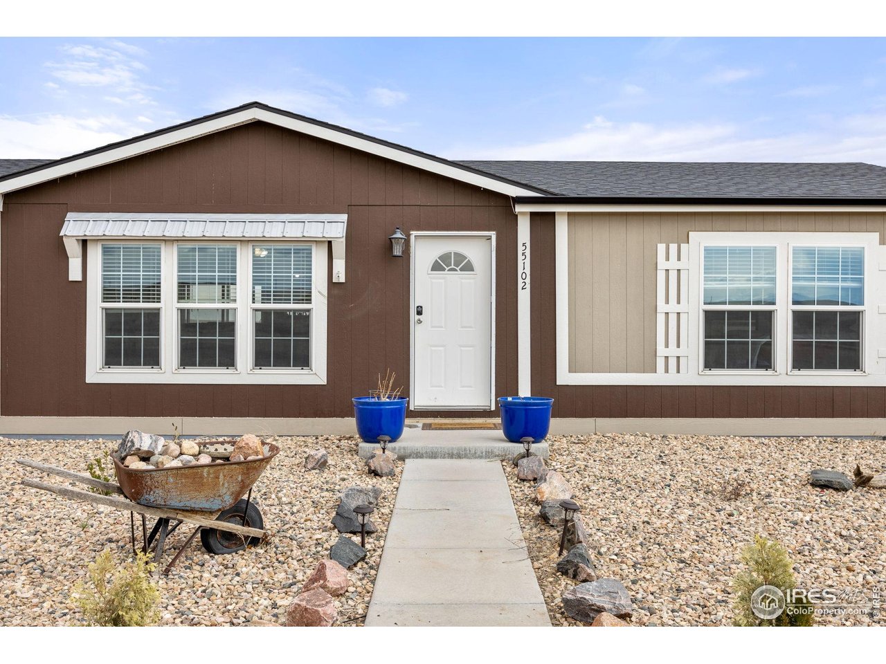 55102 County Road 21 Carr, CO 80612 - Photo 7 of 34 a front view of a house with a yard