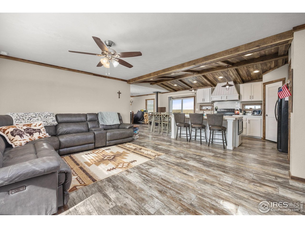 55102 County Road 21 Carr, CO 80612 - Photo 9 of 34 a living room with lots of furniture and a kitchen view
