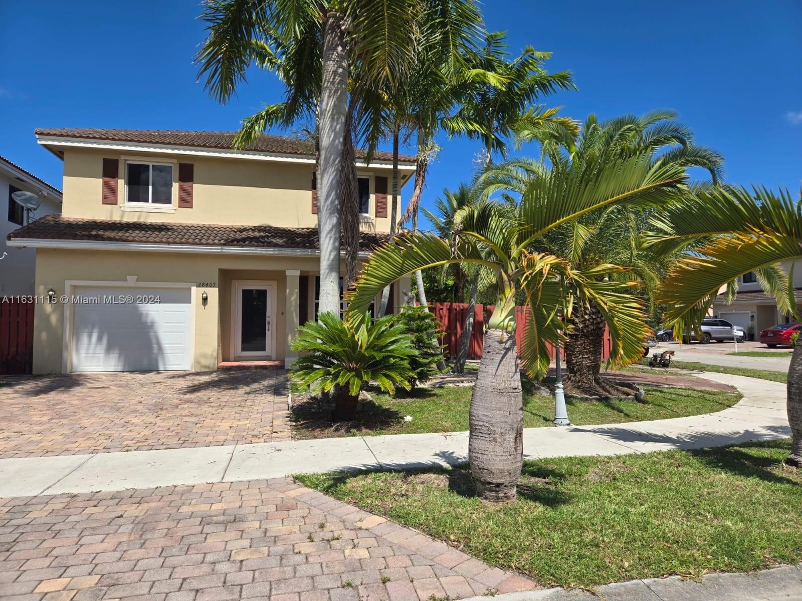 28407 Southwest 129th Place Homestead, FL 33033 - Photo 1 of 17 a palm tree sitting in front of a house with a yard